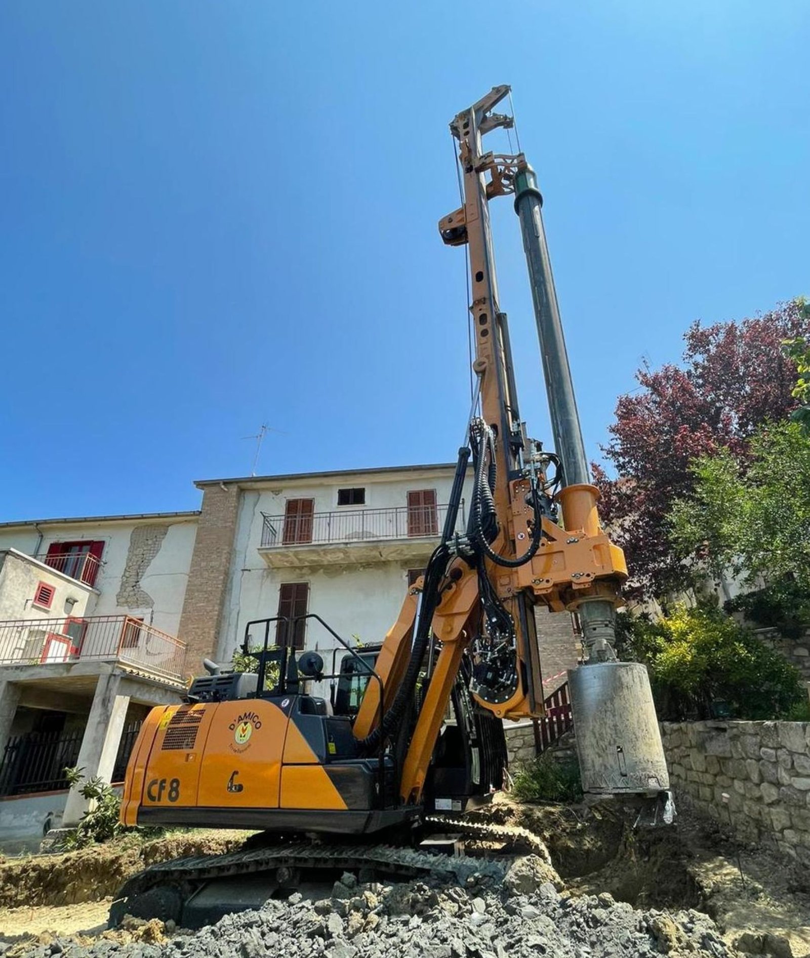 Tracked piling drill rig installing a bored pile on a construction site