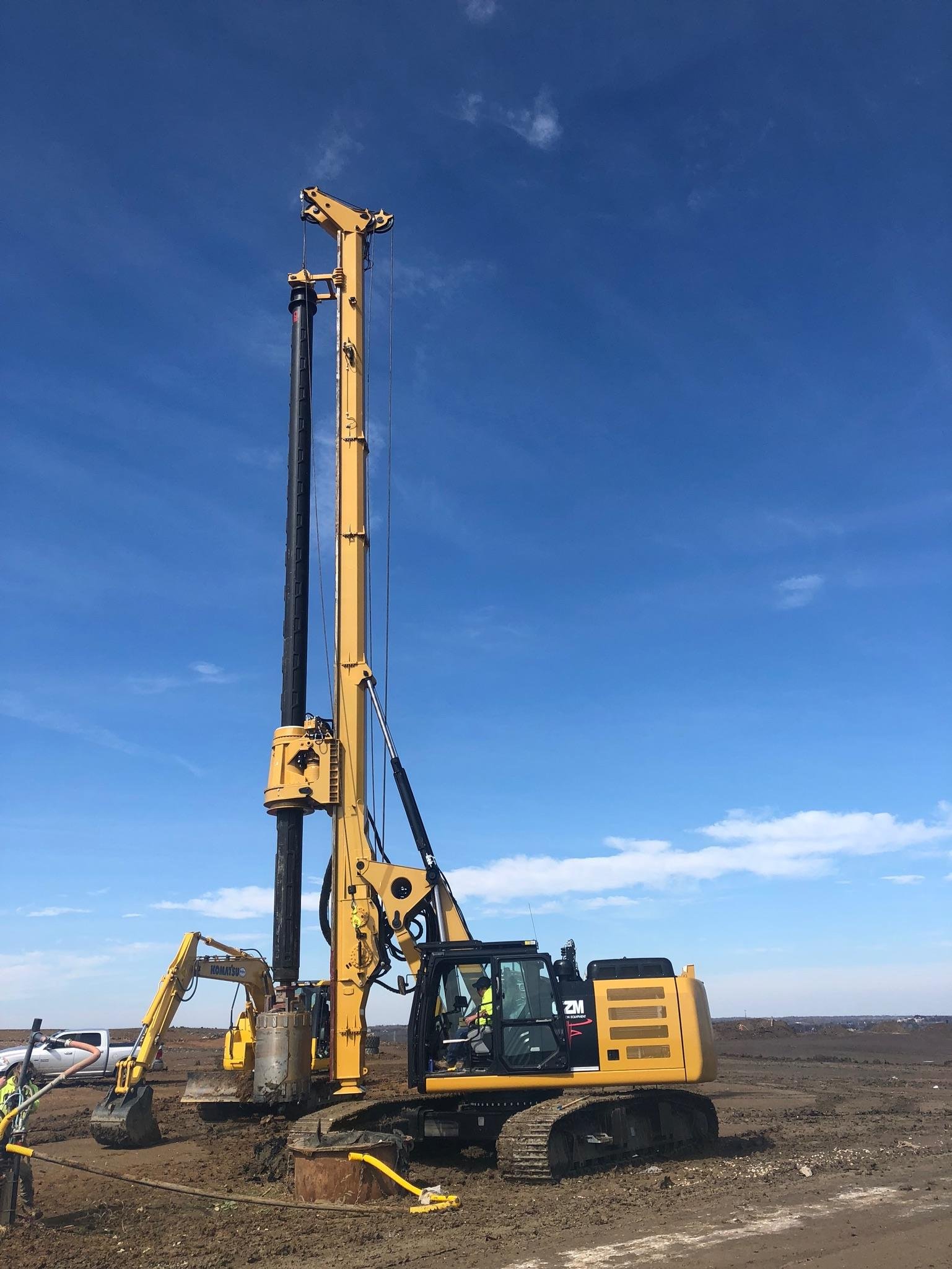 Yellow piling rig operating on a construction site